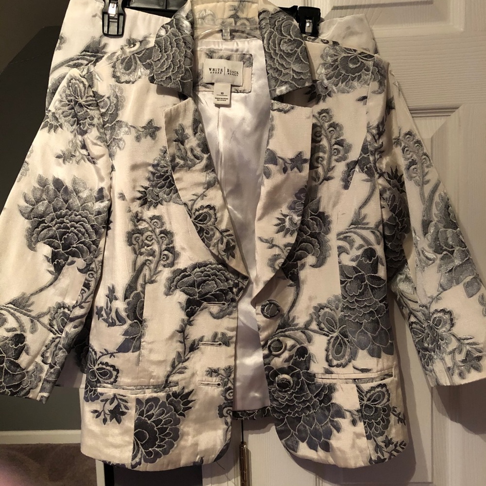 A skirt suit with silver/grey flowers all over.
